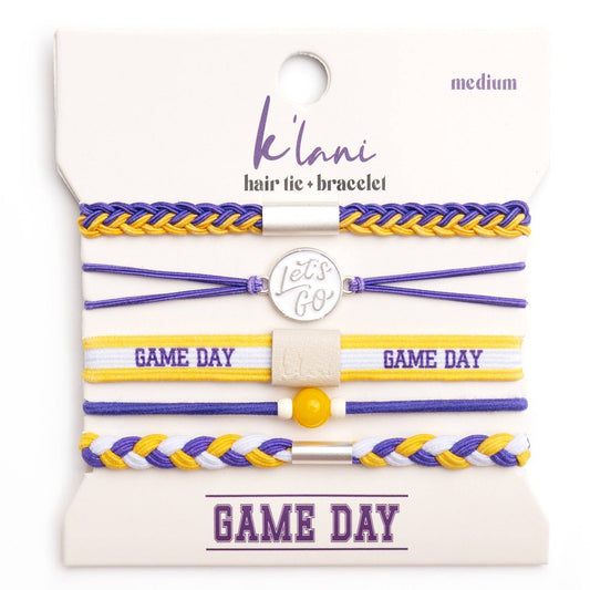 Set of hair tie and bracelets with 'Game Day' text on a branded card.