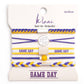 Set of hair tie and bracelets with 'Game Day' text on a branded card.