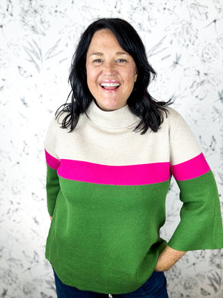 Color Me Cozy Mock Neck Sweater by FATE with 3/4 bell sleeves. Solid Color Block Print with tan upper part of sweater, pink stripe across chest and fern green at bottom half of sweater