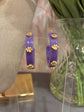 purple hoops with gold paw