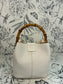 white handbag with bamboo handle