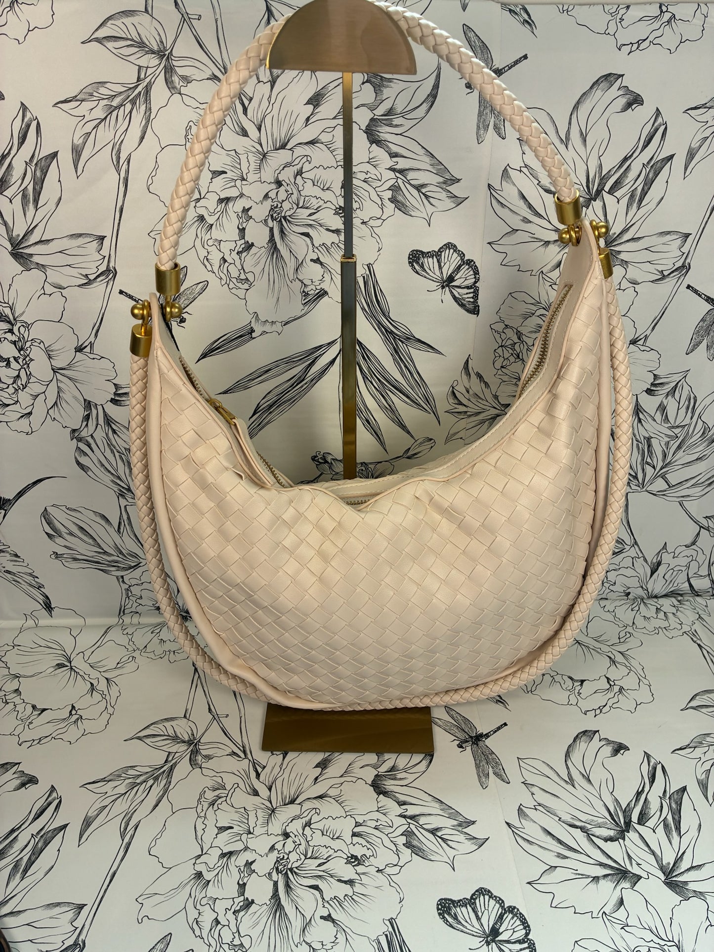 cream crescent shaped woven handbag