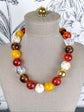 pop of joy beaded necklace in maple, rust, yellow, brown, beads