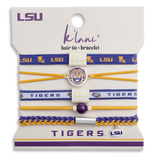 A 5-piece LSU Tigers hair tie and bracelet set by K'lan'i, displayed on its original white retail backing card. The set includes blue and gold elastic bands, a gold elastic band, a white band with purple lettering, and a braided blue and gold bracelet, featuring team logos, a tiger emblem, and a silver-tone charm.