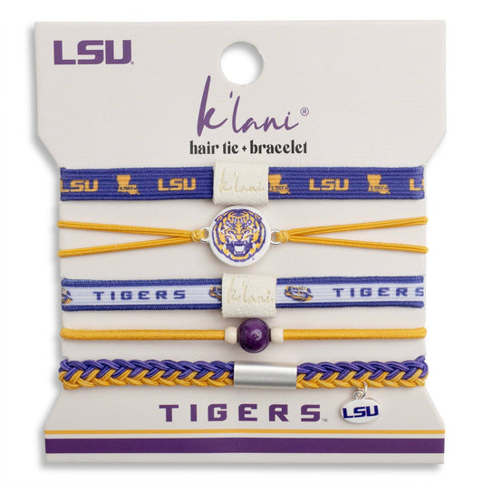 A 5-piece LSU Tigers hair tie and bracelet set by K'lan'i, displayed on its original white retail backing card. The set includes blue and gold elastic bands, a gold elastic band, a white band with purple lettering, and a braided blue and gold bracelet, featuring team logos, a tiger emblem, and a silver-tone charm.